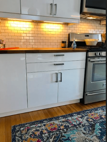 a kitchen with white cabinets