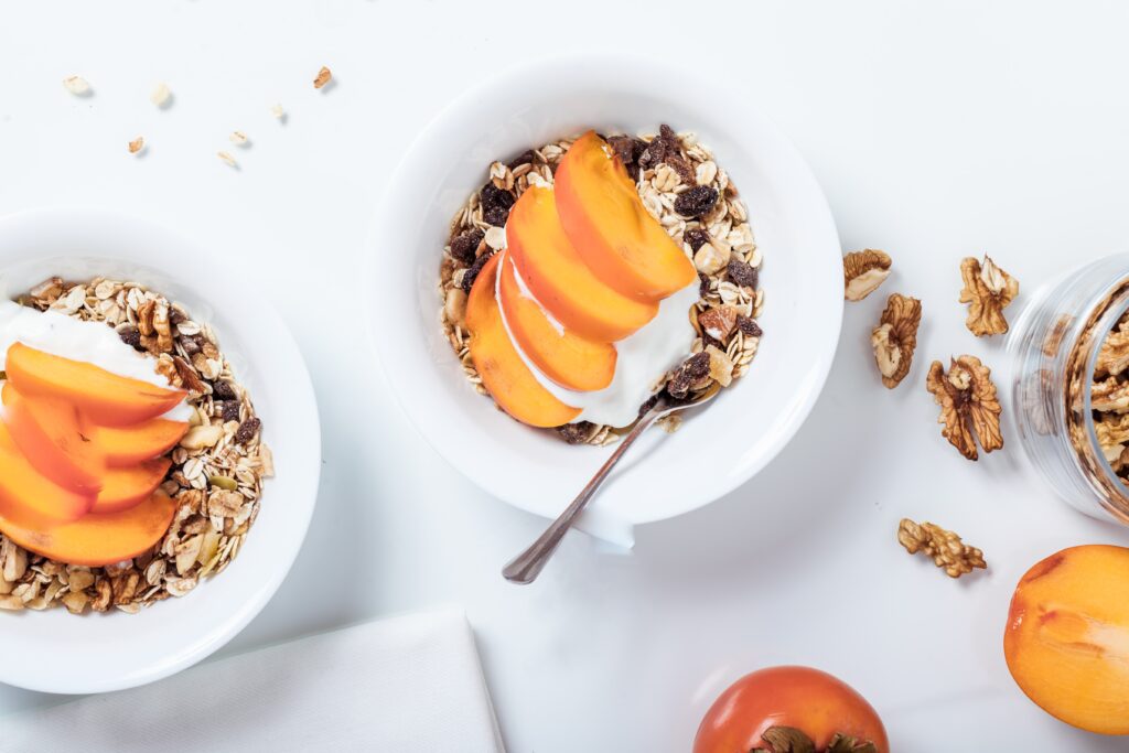 a bowl of cereal with fresh peaches on top