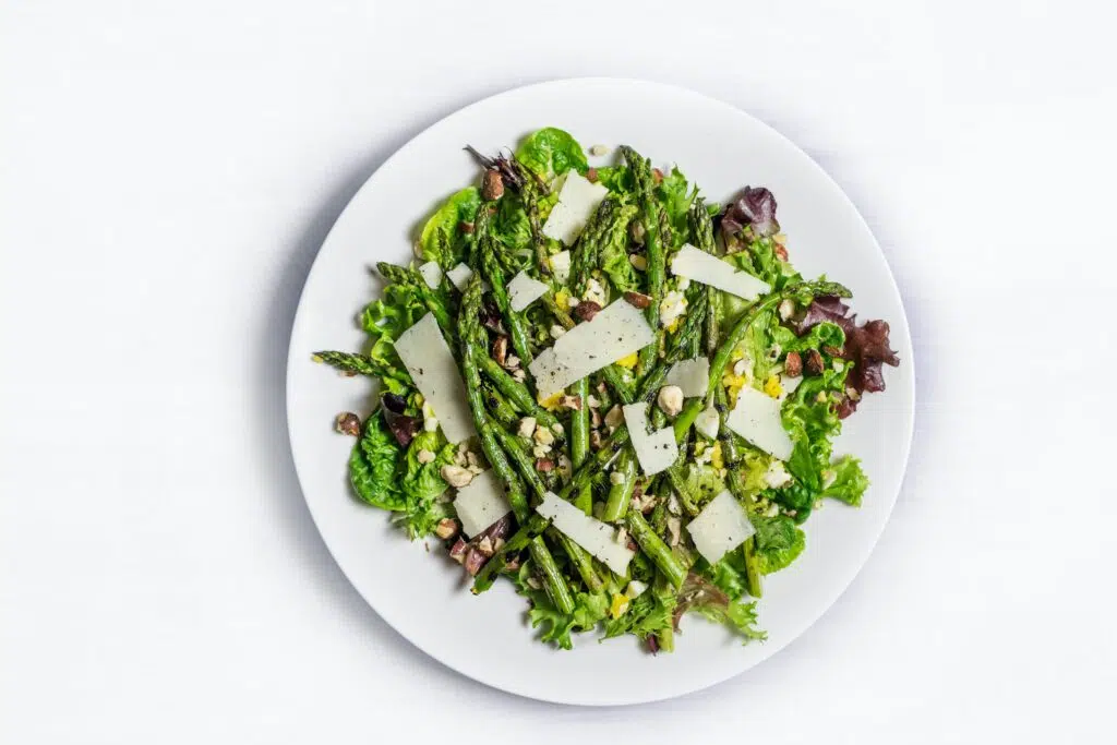 a plate full of fresh greens in a salad