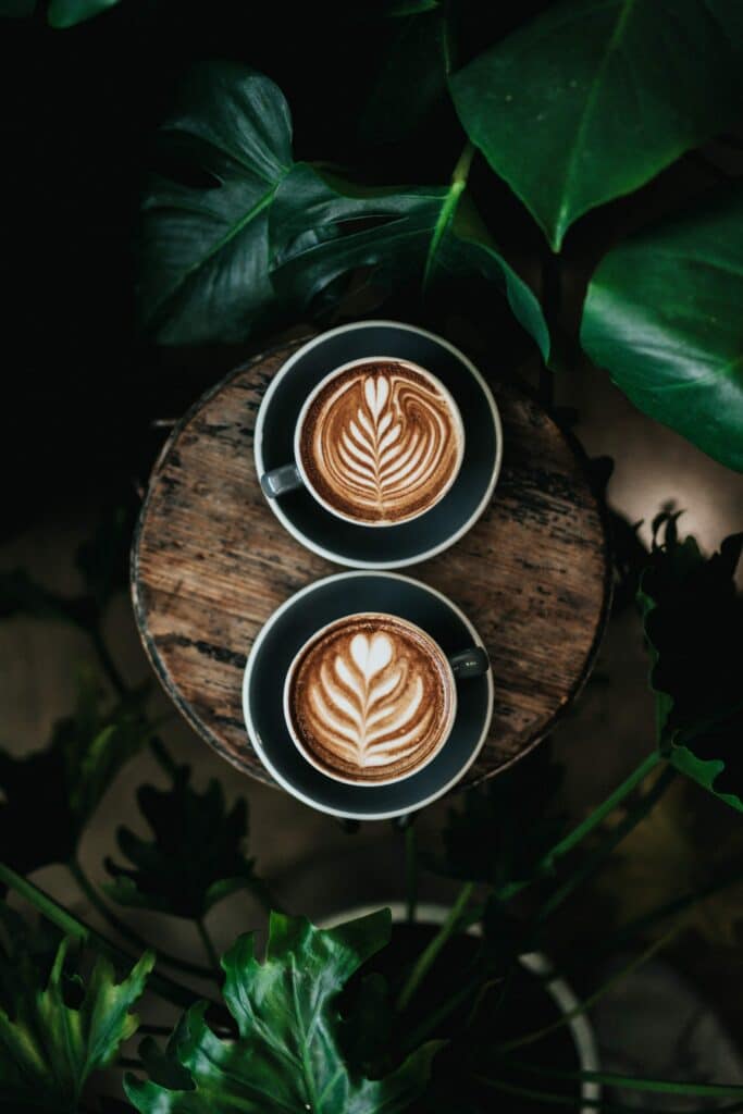 two cups of coffee with milk hearts